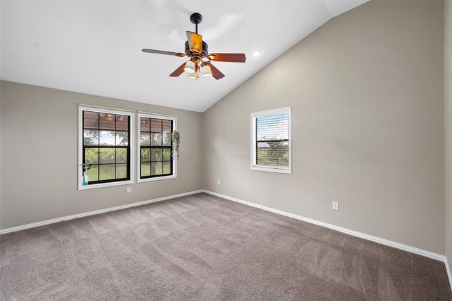 Carpeted spare room with ceiling fan, high vaulted ceiling, and recessed lighting | Image 15