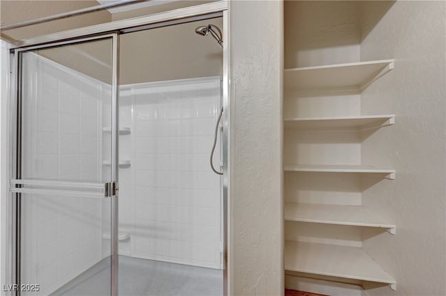 Full bath with a stall shower and a textured wall | Image 18