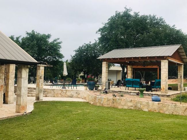 View of green lawn featuring a gazebo, a patio area, and an outdoor pool. Automatic sprinkler system in the manicured portions of lawn (front and back) | Image 24