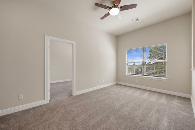 Carpeted spare room with a ceiling fan and baseboards | Image 24