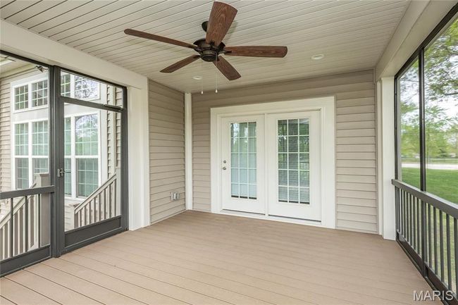 Screened in outdoor patio featuring a ceiling fan and french doors | Image 41