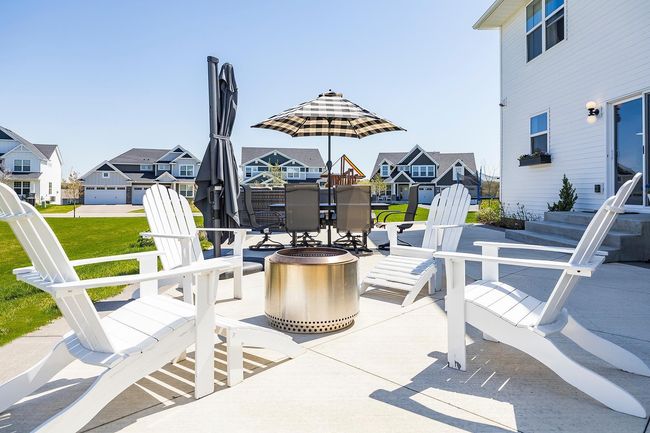 Stunning, custom patio equipped with a built-in grill, rotisserie, refrigerator, and cozy gas fireplace. | Image 37