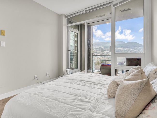 Bedroom with a mountain view, baseboards, visible vents, wood finished floors, and access to outside | Image 13