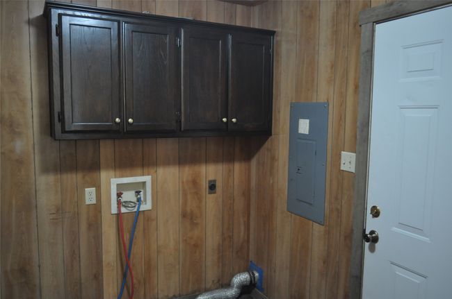 Laundry area with electric panel, washer hookup, cabinets and electric dryer hookup | Image 10
