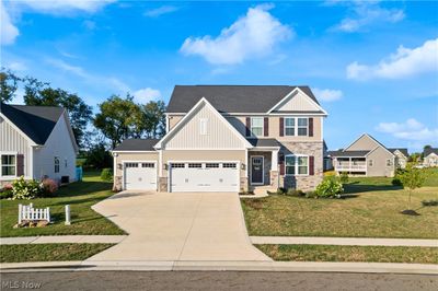 Craftsman-style home featuring a garage and a front yard | Image 1