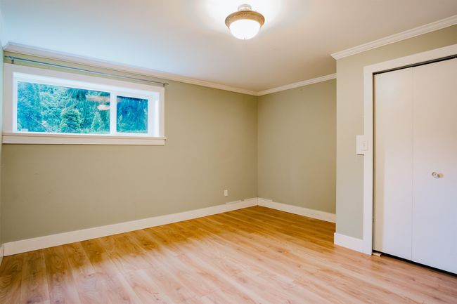 Unfurnished bedroom featuring light wood-type flooring, a closet, crown molding, and baseboards | Image 22