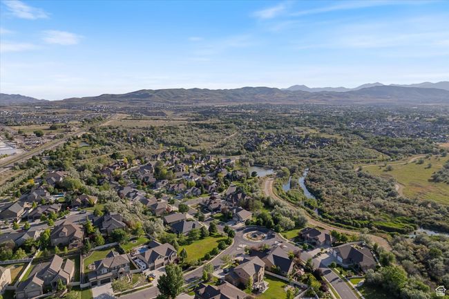 Aerial overview of property's location with mountains and nearby suburban area | Image 26