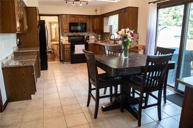Dining area featuring plenty of natural light and light tile patterned floors | Image 21