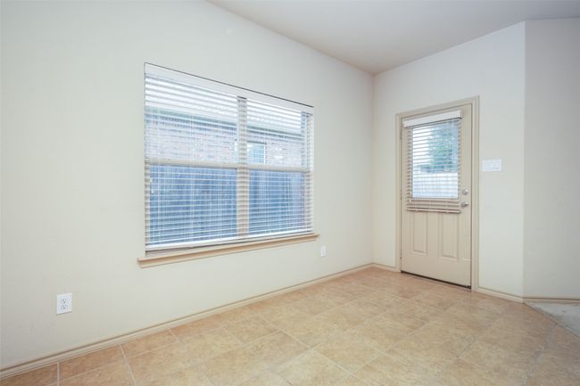 Empty room featuring plenty of natural light | Image 10