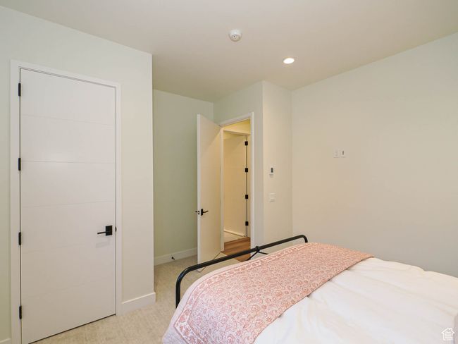Bedroom with light colored carpet and recessed lighting | Image 80