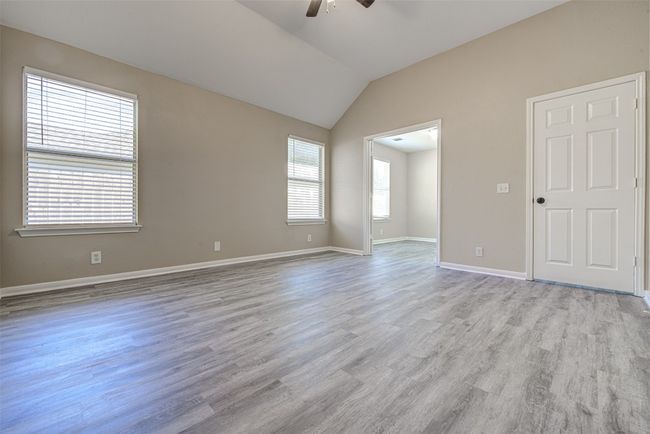 Unfurnished room with ceiling fan, light wood-style floors, and lofted ceiling | Image 14