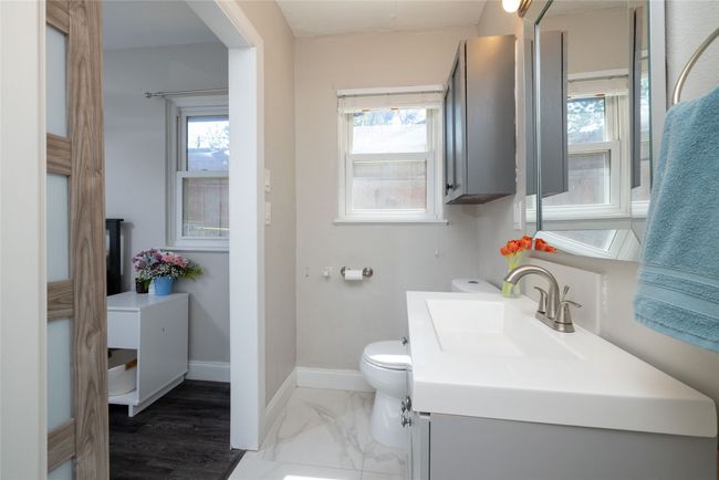 Bathroom with toilet, marble finish floor, vanity, and baseboards | Image 30
