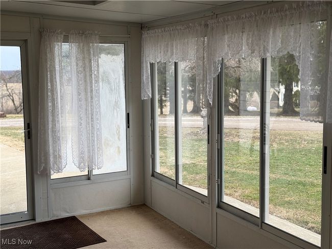 View of unfurnished sunroom | Image 21