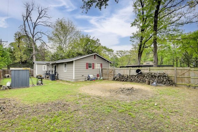 Peaceful back and side yard, with privacy fence and access to the carport. | Image 23