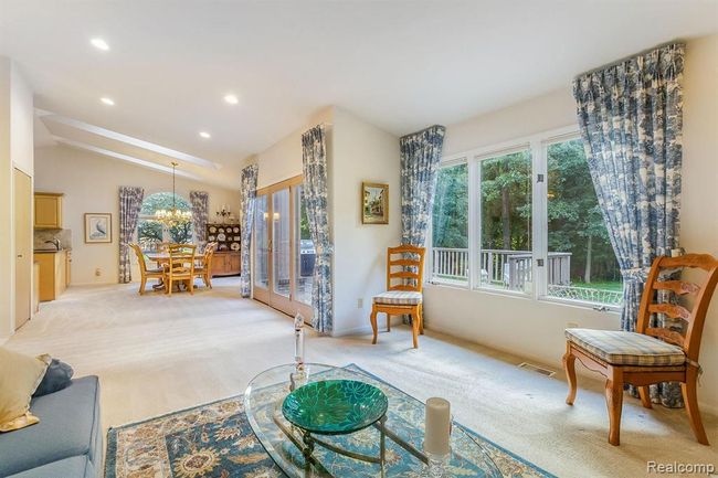 View from Living Room into Dining Area and Private Wooded Backyard | Image 8