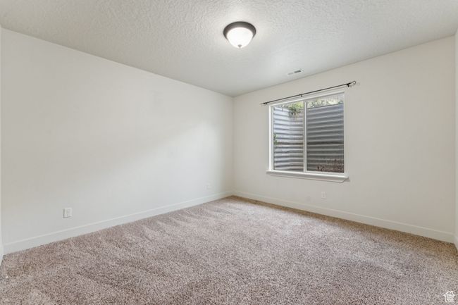 Unfurnished room featuring carpet floors, baseboards, and a textured ceiling | Image 15