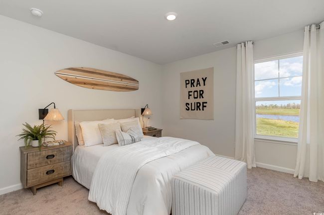 Bedroom with baseboards, light carpet, a water view, and visible vents | Image 23