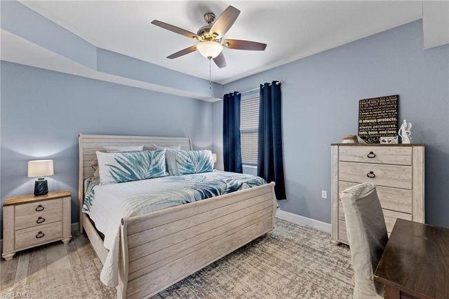 Bedroom featuring lvp wood-style flooring and ceiling fan | Image 14
