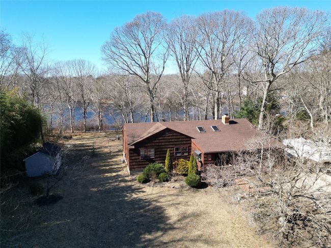View of front facade featuring a shingled roof and a chimney | Image 26