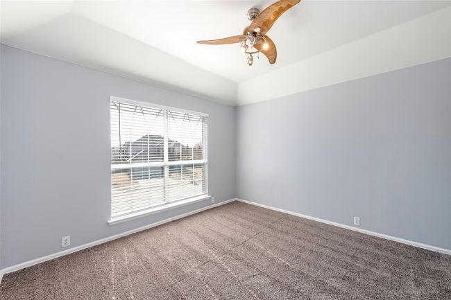 Spare room featuring carpet floors, vaulted ceiling, baseboards, and ceiling fan | Image 34