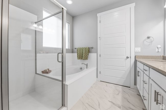 Full bathroom featuring recessed lighting, marble finish floor, a shower stall, a garden tub, and vanity | Image 22