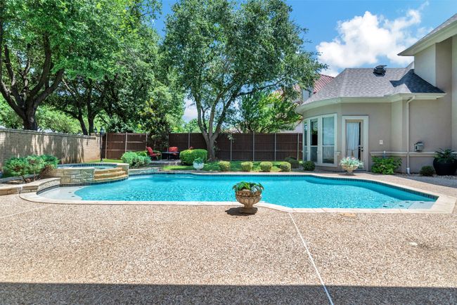 This pool was made for fun! Now that the summer heat is upon us, you'll want to stay in the cool water as much as possible. Several submerged seating areas, plus the spa, make this possible! | Image 31