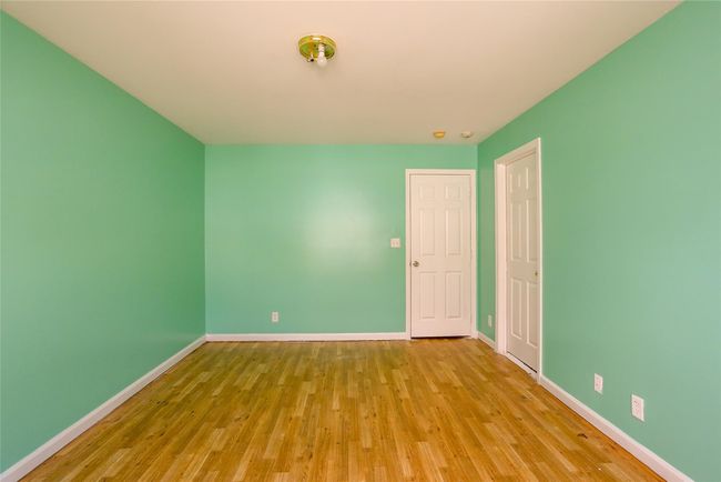 Unfurnished room with wood finished floors and baseboards | Image 9