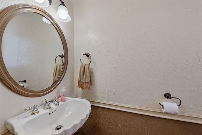 Half bath downstairs is located off the utility room, making it easy to access for the pool. | Image 17