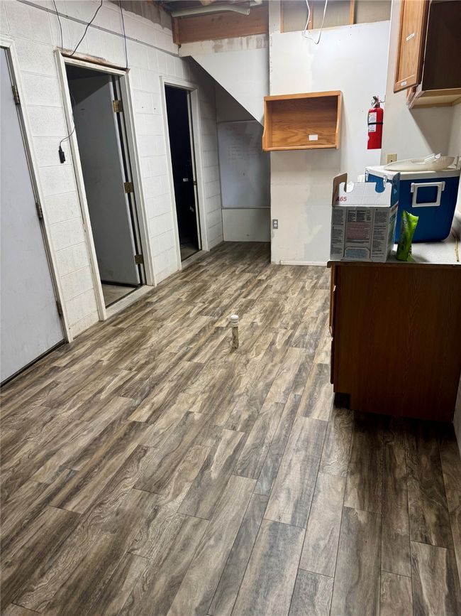 Potential 1st floor kitchen featuring new dark wood-type flooring | Image 99