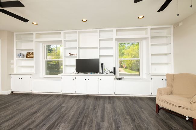Unfurnished living room with plenty of natural light, dark wood-style floors, and a ceiling fan | Image 8