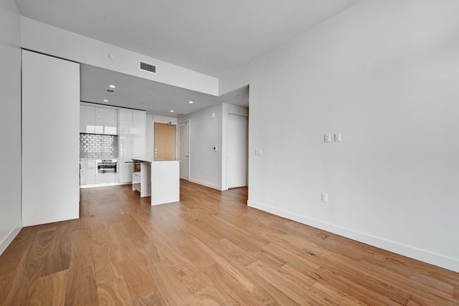 Unfurnished living room with recessed lighting, light wood-type flooring, visible vents, and baseboards | Image 6