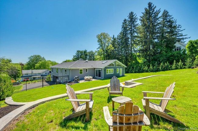View of yard with an outdoor fire pit and a patio area | Image 29