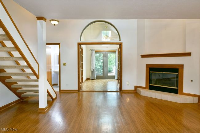 Foyer featuring wood finished floors, stairway, and a tiled fireplace | Image 10