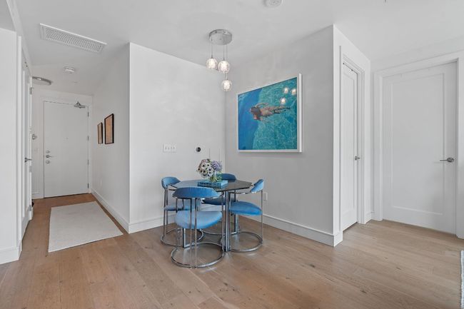 Unfurnished dining area with hardwood / wood-style floors, baseboards, and attic access | Image 9