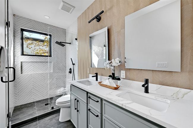 Bathroom featuring tile patterned floors, toilet, vanity, and an enclosed shower | Image 5
