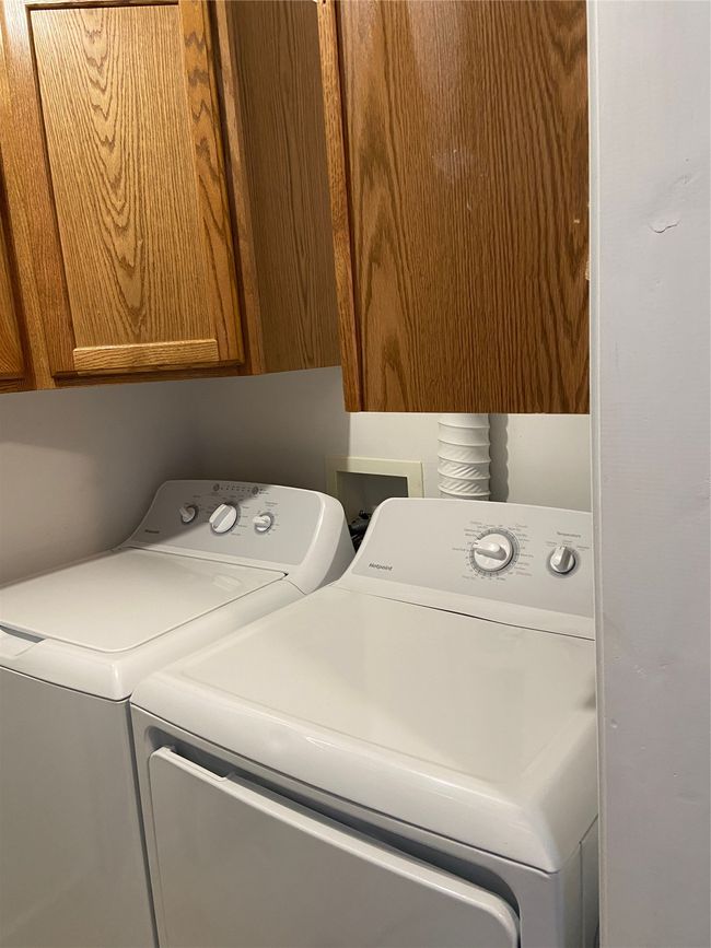 Washroom featuring washer and dryer and cabinet space | Image 13