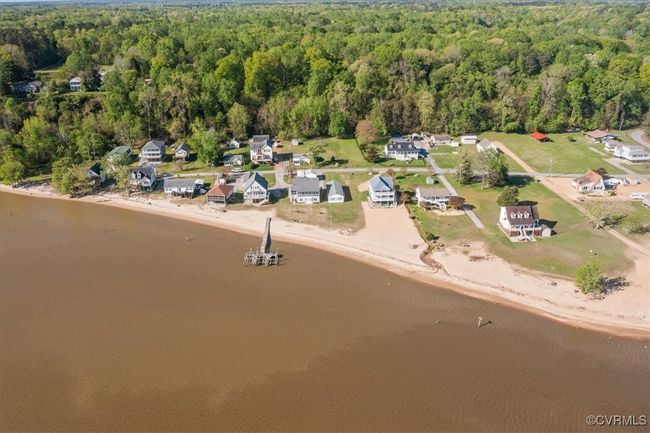 Birds eye view of property featuring a forest view, a residential view, and a water view. | Image 35
