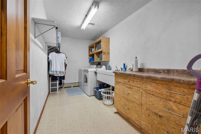 Washroom with washer and clothes dryer and light floors | Image 84