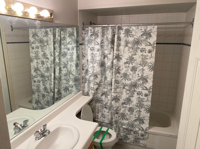 Bathroom featuring toilet, shower / bath combo, and vanity | Image 6