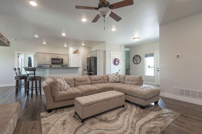 Living area with a ceiling fan, wood finished floors, and recessed lighting | Image 8
