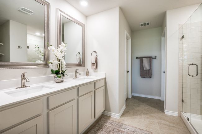 Bathroom featuring a shower stall, double vanity, tile patterned flooring, and recessed lighting | Image 22