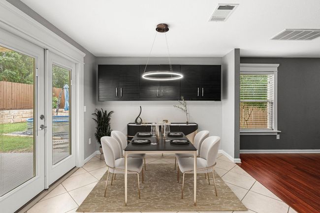 Dining space featuring light tile patterned floors and french doors | Image 6