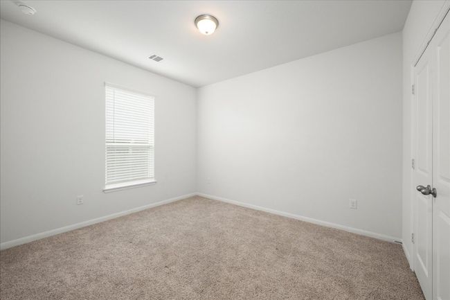 Secondary bedroom with a closet, carpet floors, and baseboards | Image 29