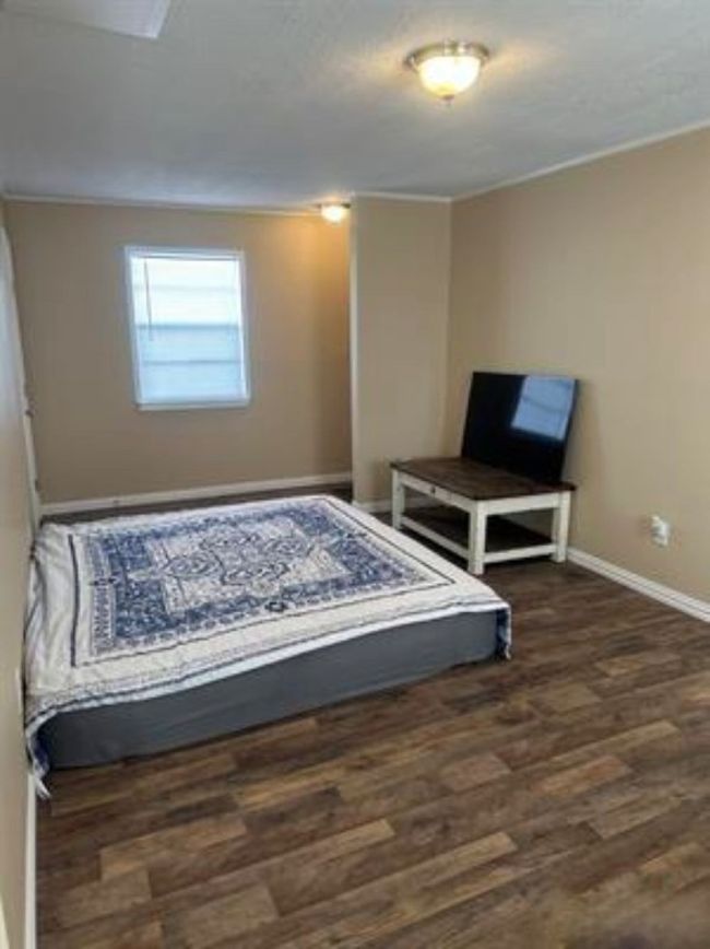 Bedroom with wood finished floors, baseboards, and ornamental molding | Image 12