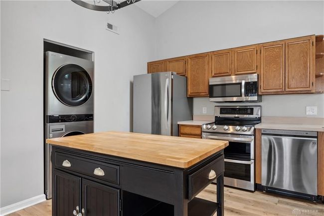 kitchen with island and washer dryer in unit | Image 7