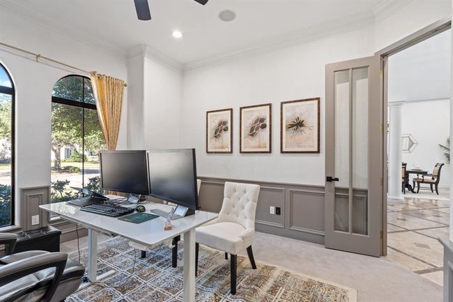 Another perspective of the home office, highlighting the peaceful atmosphere with abundant natural light from the arched windows. Double doors provide privacy, and built-in storage adds both function and style. | Image 18