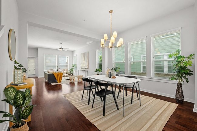 The dining area effortlessly connects to the living room and kitchen, creating a harmonious flow that's ideal for both entertaining and relaxed living | Image 7