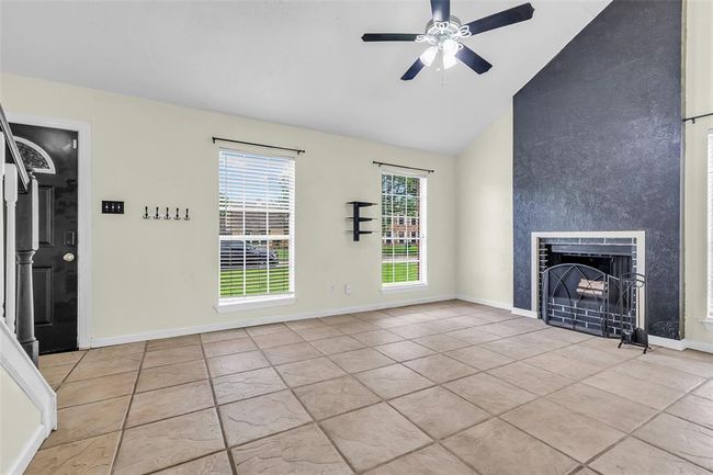 It faces the front yard and features a fireplace, creating a comfortable space to relax or gather. | Image 6