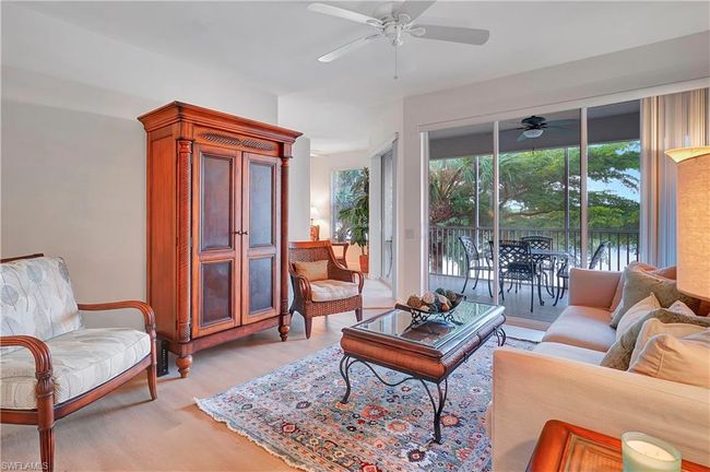 Living room featuring ceiling fan and light hardwood / wood-style flooring | Image 5
