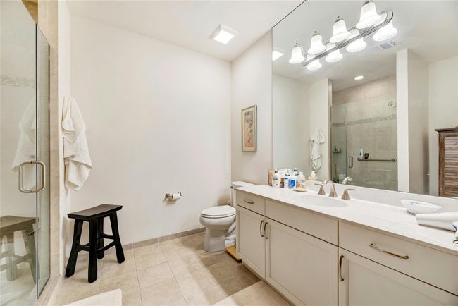 Full bathroom featuring vanity, a shower stall, and tile patterned floors | Image 13